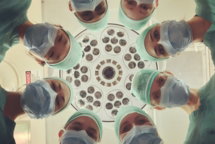 surgeons looking down under operating light